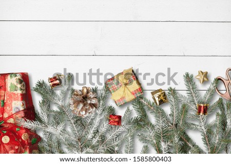 Christmas frame flat lay with pine, presents elements template on wooden desk