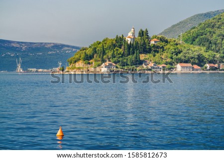 Sunny morning view of Kotor bay and coastal road near Tivat, Montenegro. 