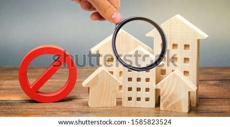 Wooden houses and a prohibition sign. Inaccessible and expensive housing. Restrictions and a ban on the construction of buildings. Interdictions within settlements. Inaccessibility Index