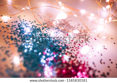 Splash of blue and pink sparkles on black background. Blue color of the year 2020 concept.