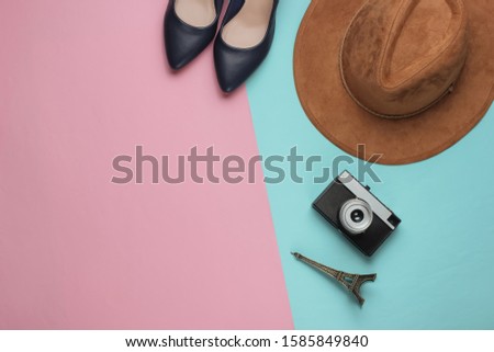 Women's accessories on pink blue paper background. Pastel color trend. Trip to the Paris, shopping concept. Top view. Flat lay