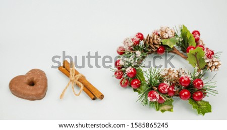 Christmas gingerbread and cinnamon with christmas wreath. on a light background. Traditional christmas baking. Banner. copyspace