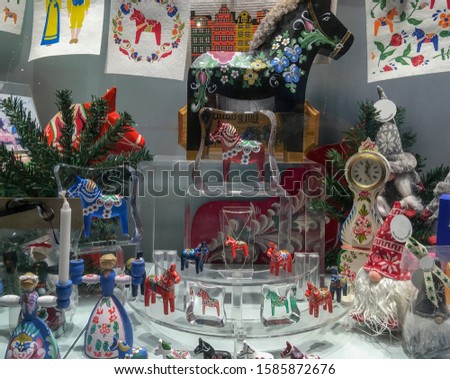 Christmas decoration with wooden horses, dwarfs, dolls, candles, Christmas tree branch and decorative clock.