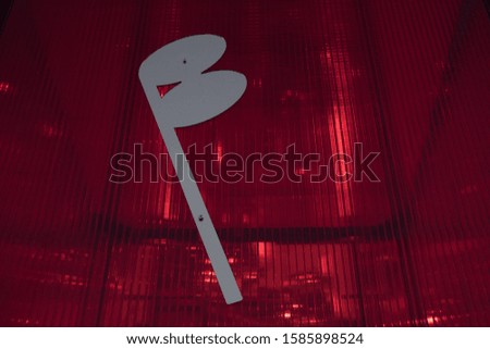 A musical note, on a red light cube.