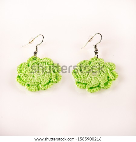 Pair of handmade knitted green ear-rings. Ideal for Christmas present. Picture taken on a white background, and ready for use.