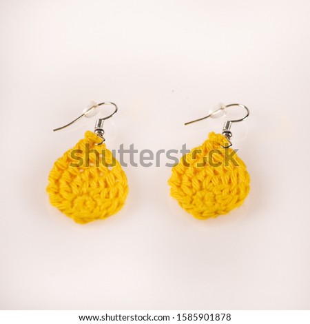 Pair of handmade knitted yellow ear-rings. Ideal for Christmas present. Picture taken on a white background, and ready for use.