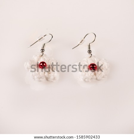 Pair of handmade knitted white ear-rings. Ideal for Christmas present. Picture taken on a white background, and ready for use.