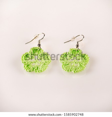Pair of handmade knitted green ear-rings. Ideal for Christmas present. Picture taken on a white background, and ready for use.