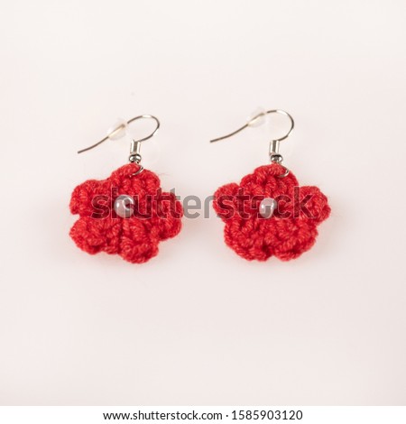 Pair of handmade knitted red ear-rings. Ideal for Christmas present. Picture taken on a white background, and ready for use.
