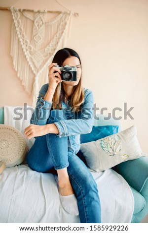 Woman Recording. Closeup portrait young man photographer girl shooting images taking photos with copyspace isolated wall background. Human facial expression emotion feelings body language