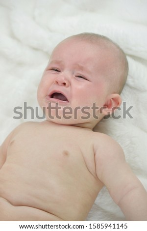 baby boy crying on blanket