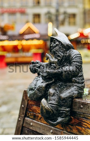 gnome figurine with toy horse outside christmas garland symbol wroclaw poland