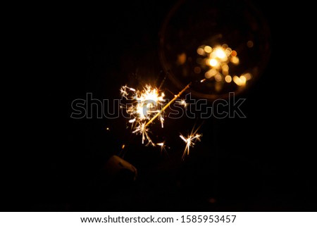 Bengal fire and sparks macro photo festive bokeh background Christmas and New Year