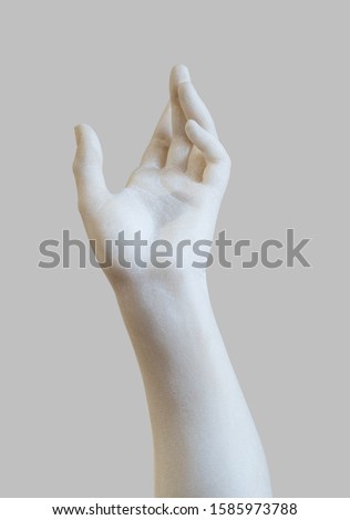 side view closeup of white stone marble statue hand reaching out to the heavens isolated on grey background Royalty-Free Stock Photo #1585973788