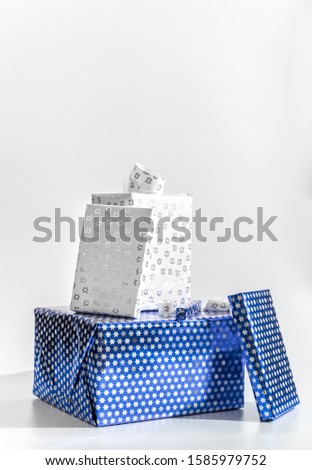 Hanukkah gifts wrapped in Star of David wrapping paper. Presents to celebrate the Jewish holiday of Chanukah.