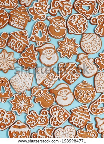 Handmade Christmas gingerbread on a blue background. New Year's concept. View from above