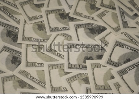 Photo of hundred dollar bills close up