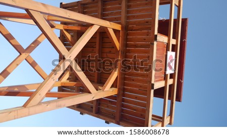 A lifeguard wooden tower on the sandy beach known as Racó, which is in the seaside town of Cullera. The photo was taken at the sunrise in Valencia, Spain, Europe.