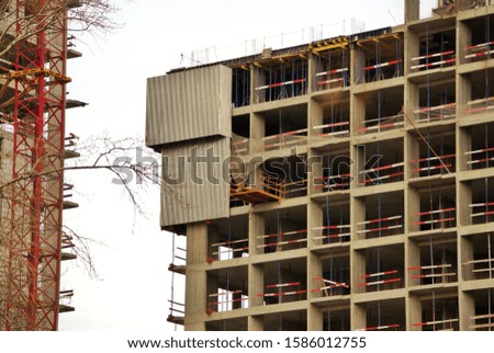 Photo of a multistory building under construction. Urban housing
