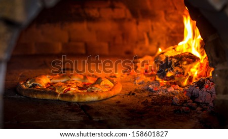 pizza in the oven Royalty-Free Stock Photo #158601827