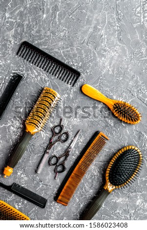 hairdressing concept with barber tools on gray background top view mock-up