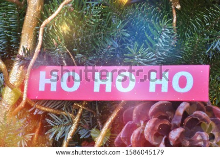 red tag with Ho ho ho, Santa's laugh on a Christmas tree