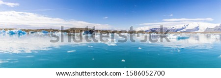 Panoramic pictures over Joekularson glacier lagoon with frifting iceberg in summer