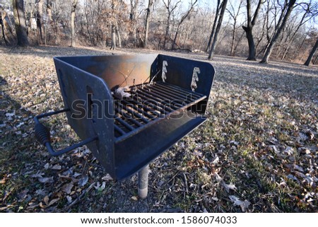 Outdoor barbecue grill in a field in Kansas City, Missouri. Picture taken on a cold day in December.