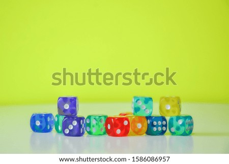 Beautiful colorful dices in a white and green background