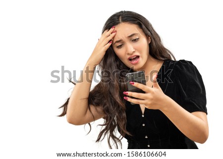 expression and people concept - angry woman with cell phone funny face over white background. Adult over 20 years of age.