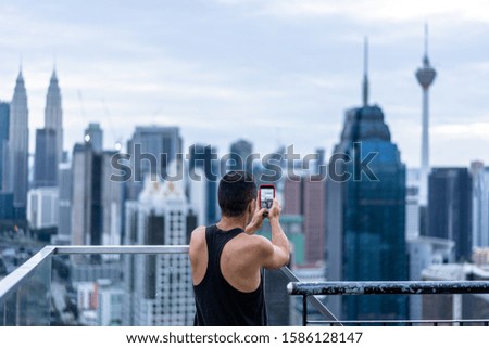 young man  with city skyline in kuala lunpur