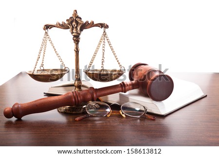 Bronze scales, gavel, glasses and a book on the table