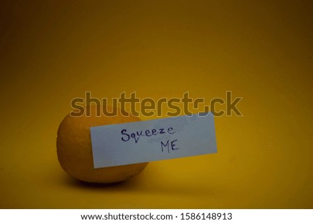 this Photo contains lemon with written stick paper .its background is blue and yellow.