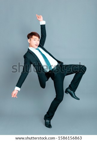 Happy young business man dancing in motion