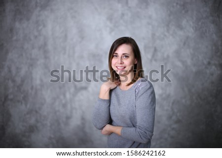 portrait of a beautiful woman with brown hair on a gray background different positive emotions