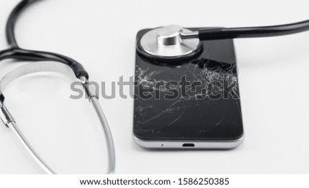 Diagnosing the phone with a stethoscope, near a screwdriver. Phone repair concept