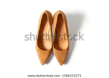 Beige shoes with a sharp nose heels on an isolated white background.