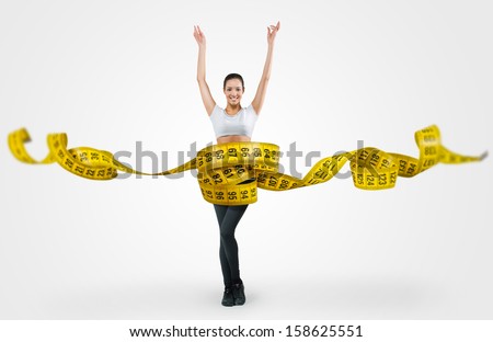 Fit young woman with a large measuring tape Royalty-Free Stock Photo #158625551