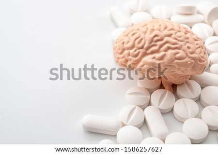 Nootropics use to improve memory and neural function, smart drugs and cognitive enhancers conceptual idea with brain and pills isolated on white background with copy space Royalty-Free Stock Photo #1586257627