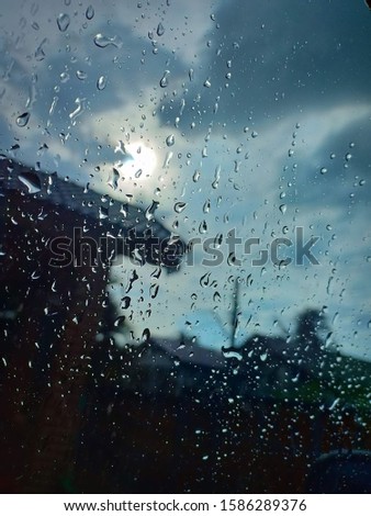 Rain drops of water scratched the glass overcast