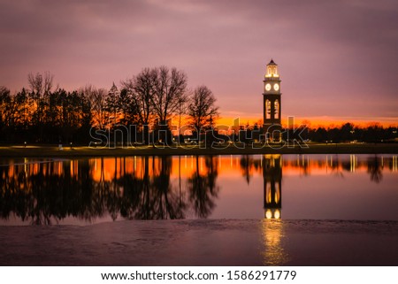 Bell tower and lake at Coxhall Garden in Carmel Indiana at sunset in the winter of 2019 Royalty-Free Stock Photo #1586291779
