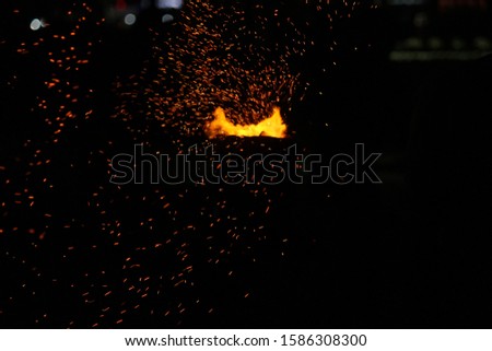 Corn being cooked on coal near beach with some fire spark . A corn roaster sparkling fire in the shores of Marina Beach, Chennai, India on night