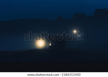 cabin in the night fog. lonely shack at night. scary creepy house at night in a swamp.