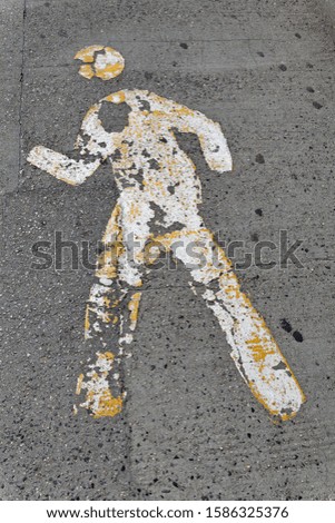 Pedestrian silhouette painted white on the floor.