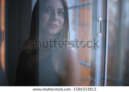Stylish young beautiful girl with dark hair in a good mood