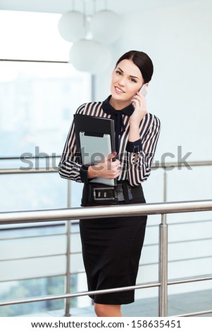 Young smiling business woman phone talking