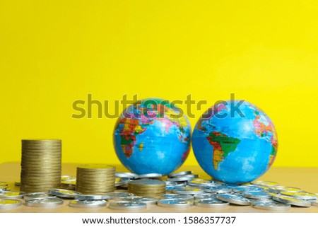 Global trade and financial concept - stack of coin with two globe object