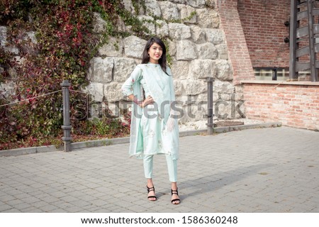 Traditional accessories of Indian girls. Girl in traditional Indian clothing, salwar kameez. Royalty-Free Stock Photo #1586360248