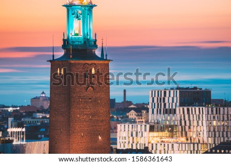 Stockholm, Sweden. Close View Of Famous Tower Of Stockholm City Hall. Popular Destination Scenic In Sunset Twilight Dusk Lights. Evening Lighting