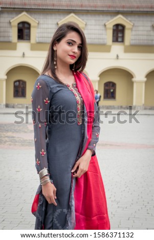 An Indian girl stands on the street of the city of Ivano-Frankivsk. Girl in traditional Indian clothing, salwar kameez. Royalty-Free Stock Photo #1586371132